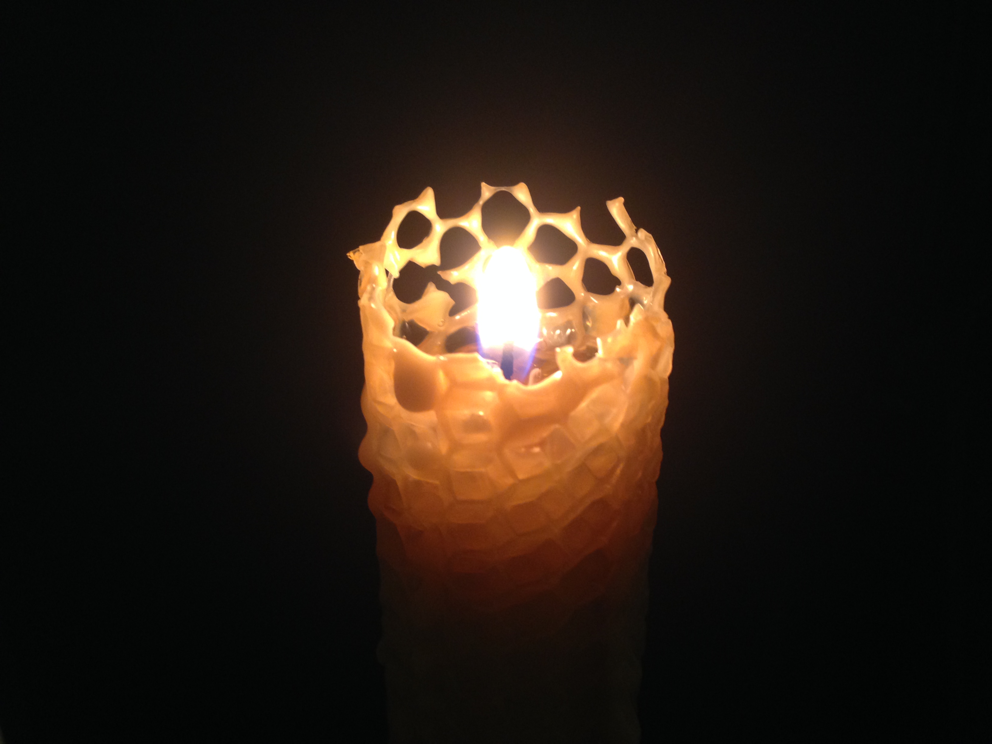 A burning wax candle